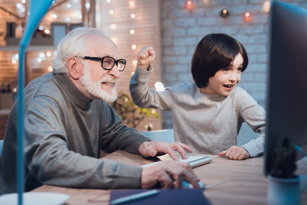 Grandpa Playing Computer Games with Grandson