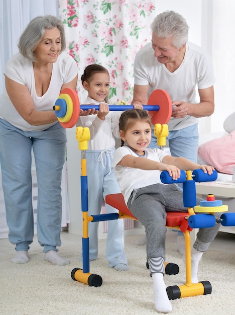 Grandparents and little granddaughters doing exercises