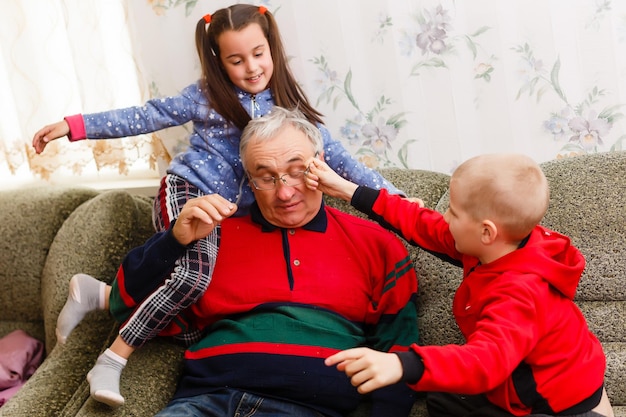 Grandparents spending time with grandchildren on couch