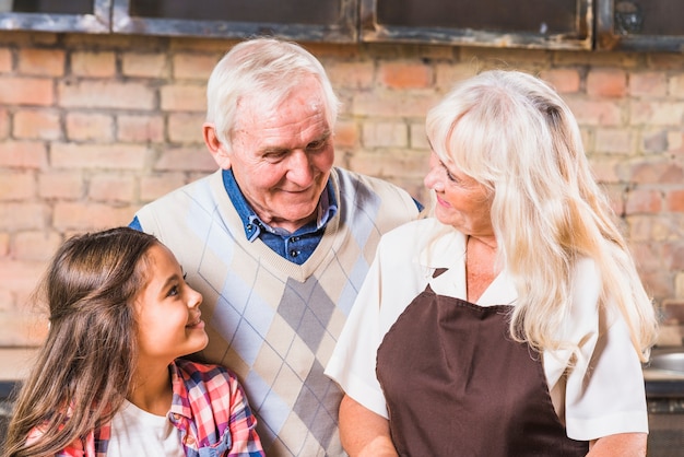 Grandparents with granddaughter in kitchen 