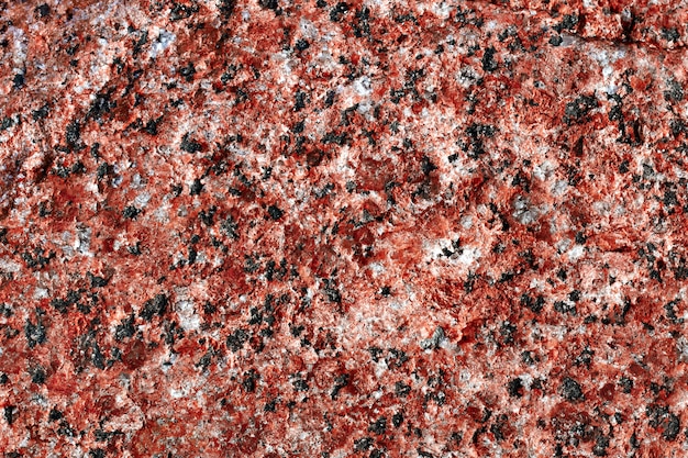 Granite background. Natural stone texture. Red surface. Pattern.