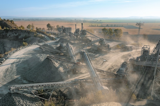 Granite quarry against a background of blue sky, large piles of stone and huge deposits of granite in the rocks