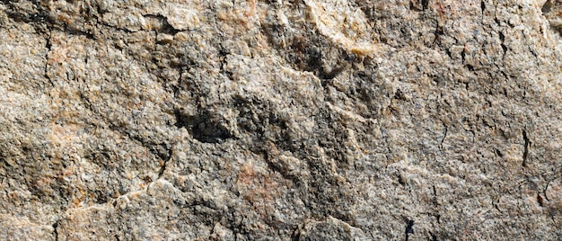 Granite stone texture. Cracked granite rock surface. Natural stone backdrop. Close-up