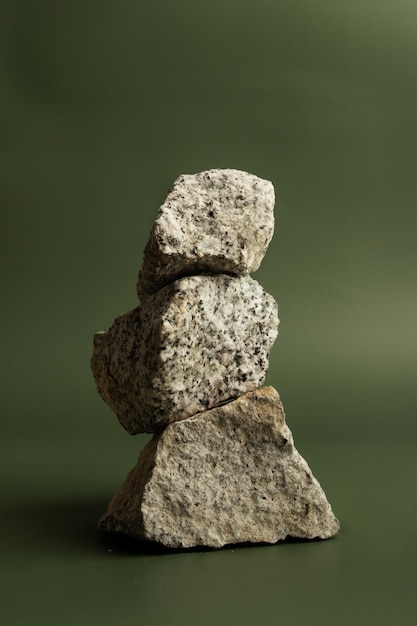 Granite stones stacked on a green background