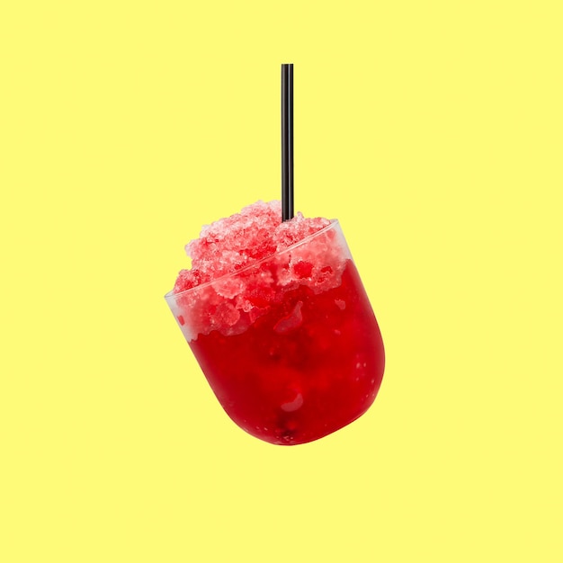 Granizado or Shaved ice with Fruit juice Red Slush drink isolated on yellow background