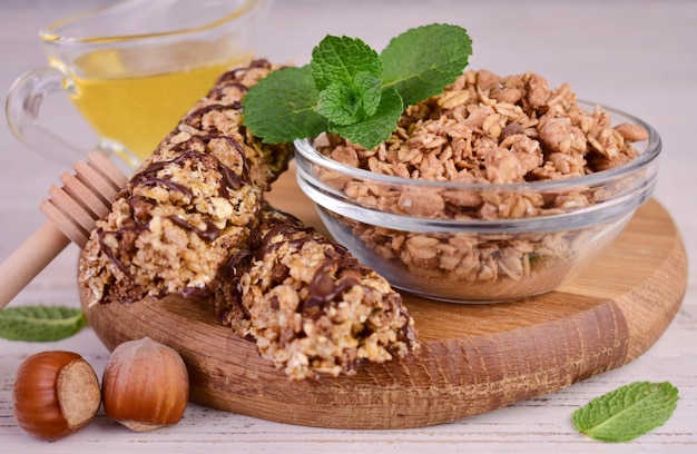 Granola in a bowl and muesli bars with honey.Healthy snack concept.