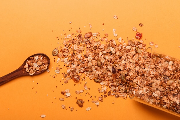 Granola in a glass jar on a yellow background