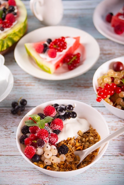 Granola muesli cereals with yogurt or milk and fresh berries Healthy breakfast concept