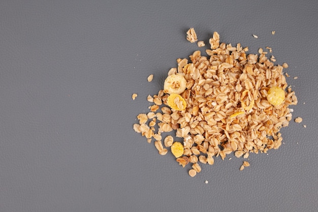 granola spread out on a gray background