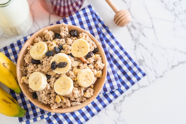 granola with banana, raisin and milk 