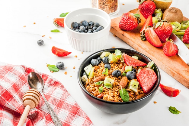 Granola with nuts, fresh berries and fruits