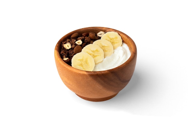 Granola with yogurt, banana and nuts isolated on white surface