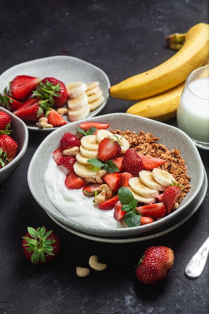 Granola with yogurt strawberry and banana in a bowl