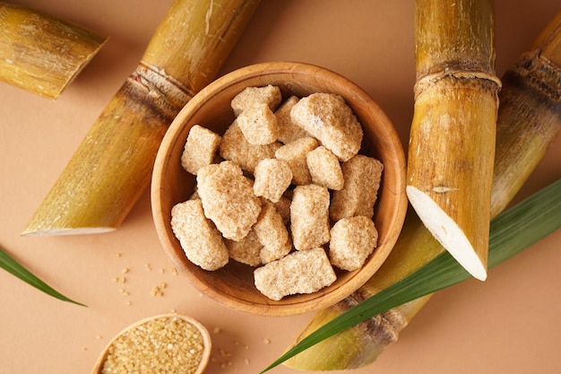 Granulated brown sugar sugarcane on a brown background Top view