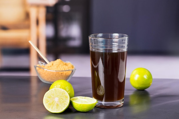 Granulated panela and agua de panela or sugar cane sweets and lemon in the kitchen typical food of Colombia