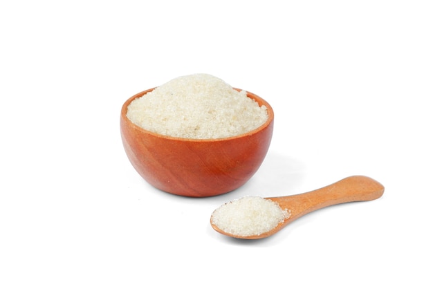 Granulated sugar with wooden bowl and spoon on white background