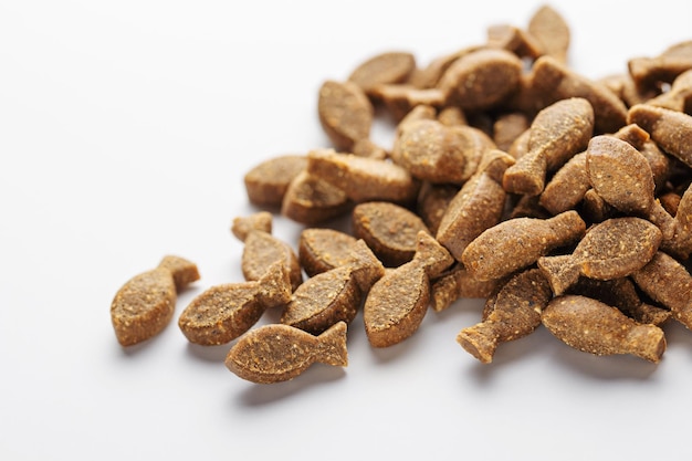 Granules of dry food for dogs on a white background