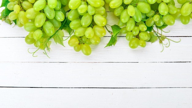 Grape Fresh white grapes on a white wooden background Top view Free space for text