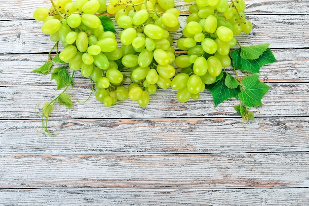 Grape Fresh white grapes on a white wooden background Top view Free space for text