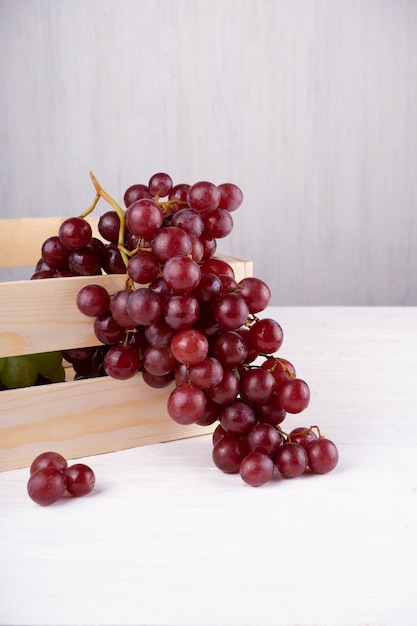 Grape harvest. red and green clusters of grapes collected in box and ready for wine production.