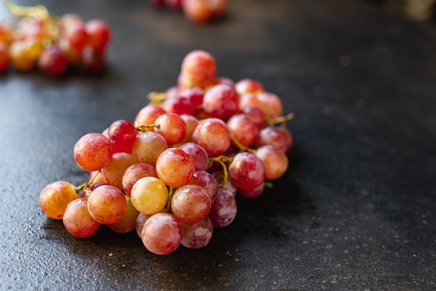 Grape red and green fruit sweet dessert healthy food ripe fresh organic meal snack on the table