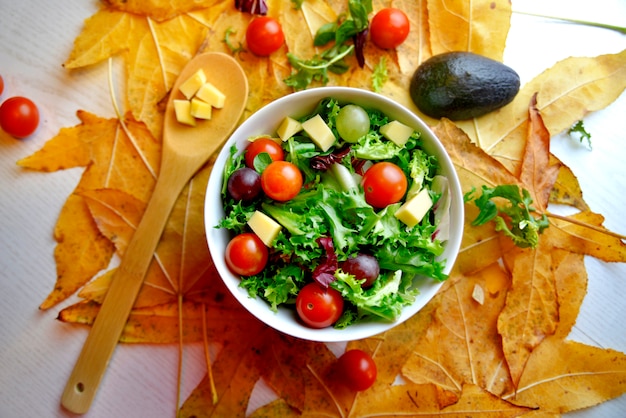 Grape salad with tomato and avocado on leaves