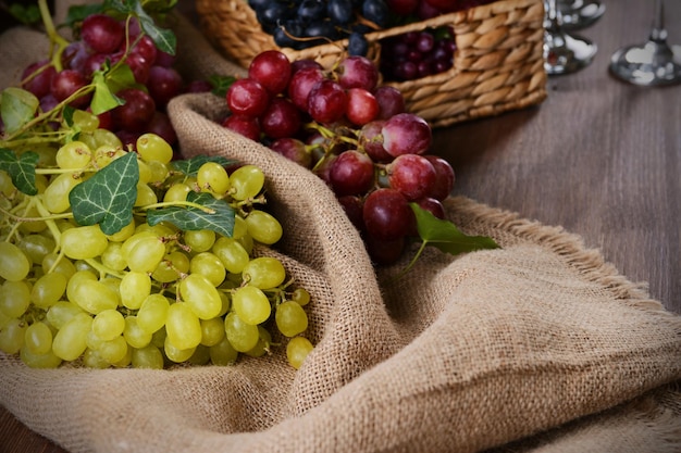 Grape in wicker box on table closeup