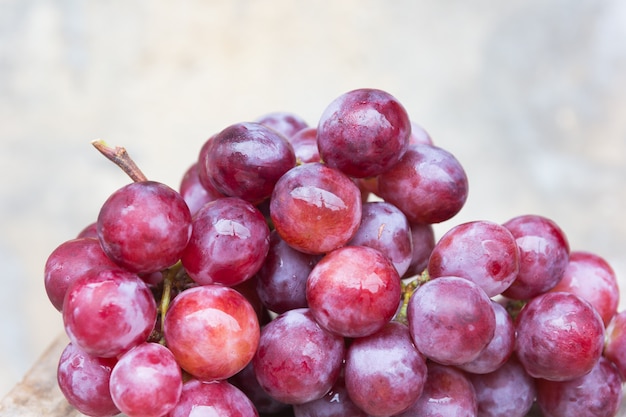 Grape with water drops, old wall 