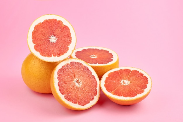 Grapefruit citrus fruits over pink background