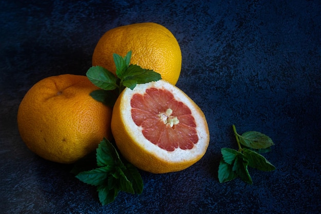 Grapefruit close-up sliced on a dark background