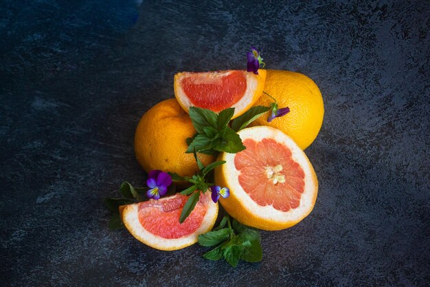 Grapefruit close-up sliced on a dark background