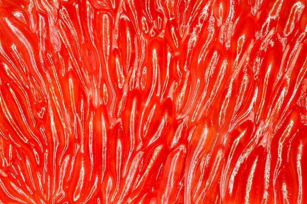 Grapefruit closeup peeled surface slices red citrus fruit macro view background wallpaper uniform texture pattern