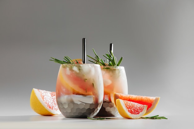 Grapefruit and Cucumber Gin Cocktail on elegant glasses on white background