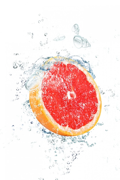 Grapefruit falling in water