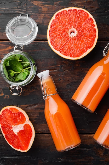 Grapefruit juice on old dark wooden table background top view flat lay