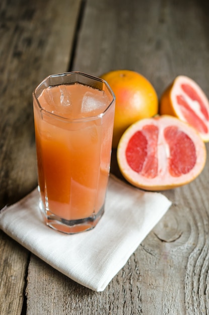 Grapefruit juice on wooden table