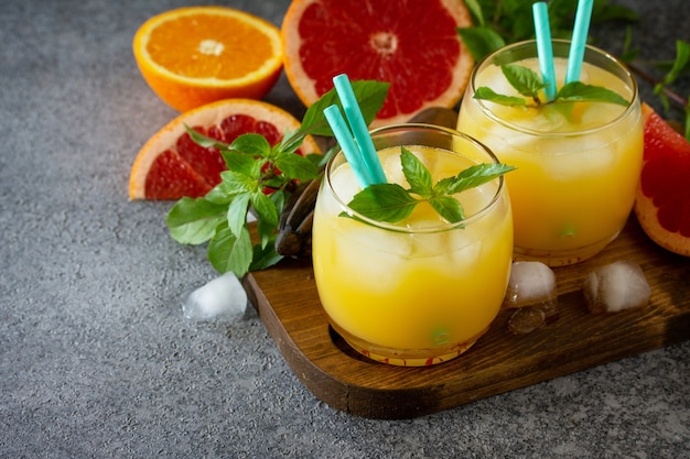 Grapefruit and orange gin cocktail or margarita refreshing drink with ice