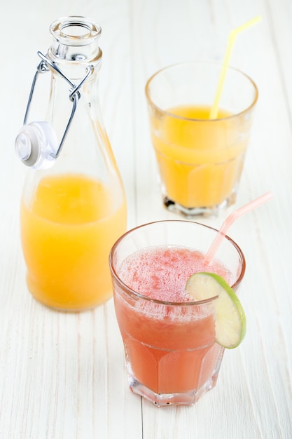 Grapefruit and orange juices in the glasses and  in the bottle