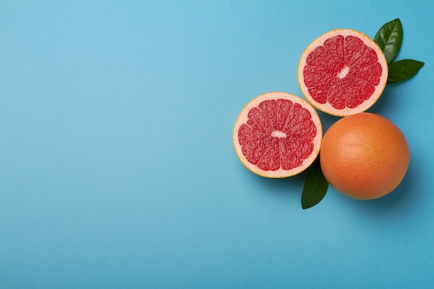 Grapefruit on pale blue background copy space