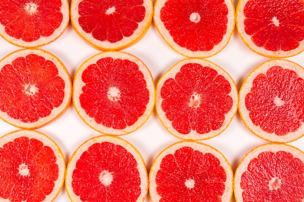 Grapefruit red juicy slices background. top view.