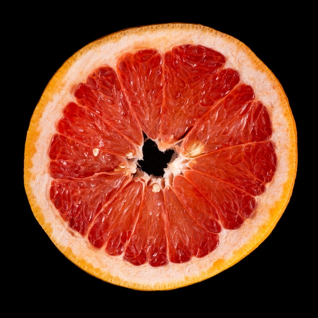 Grapefruit slice on a black background