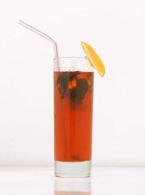 Grapefruit tea in a glass with ice and straw drink isolated on white background