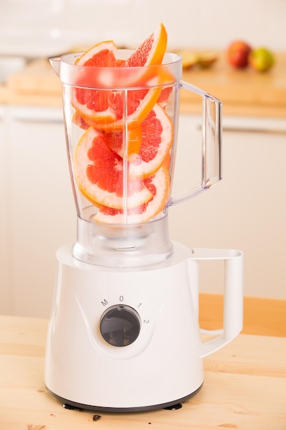 Grapefruit white Blender on a wooden table