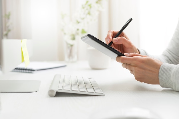 A graphic designer draws on a tablet.