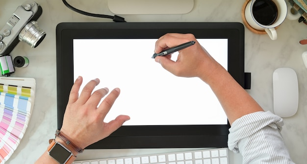 Graphic designer sketching on graphic tablet 