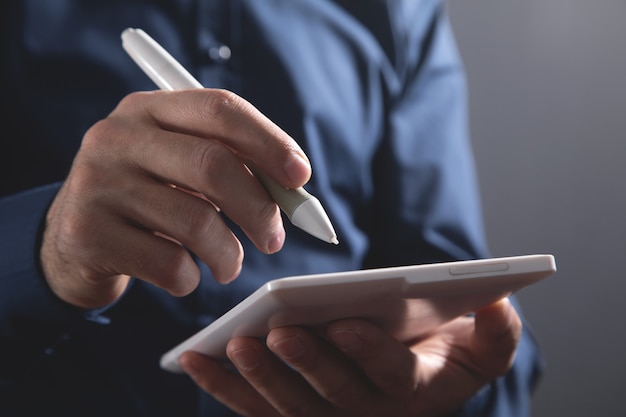 Graphic designer using tablet computer in office.