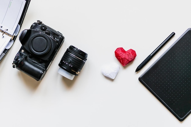 Graphic designer workstation with dslr lens agenda stylus and heart printed in 3d