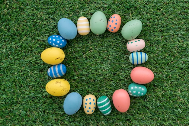 Grass background with frame made of easter eggs