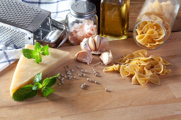 Grated parmesan cheese and metal grater on wooden board 