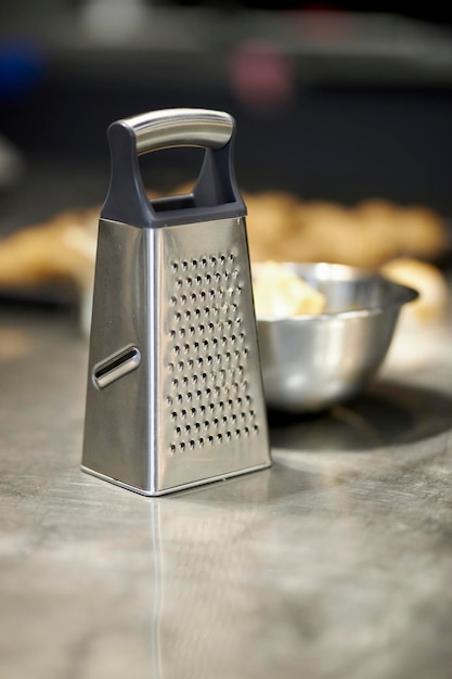 the grater is on the kitchen table. Stainless steel Grater on kitchen table. vertical image